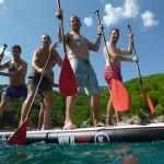 Teams having fun on top of the paddleboard